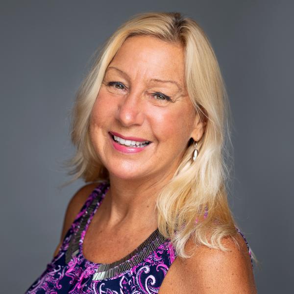 Woman with blonde hair in purple blouse